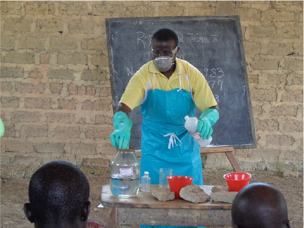 Robert W Thomas Jr , Supervisor at Firestone Liberia’s quality control department demonstrating the use of formic acid at a workshop in Gaitanyeah.